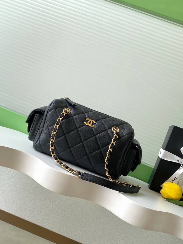 Chanel 25K pebbled leather bowling bag. The pebbled leather bowling bag with bru