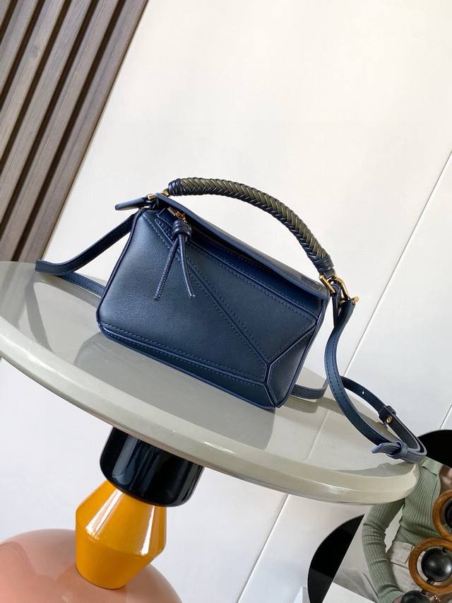 The new woven-handle mini Puzzle bag in soft calfskin leather is the first handb