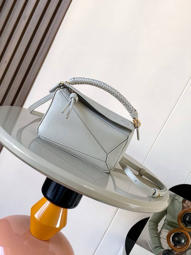 The new woven-handle mini Puzzle bag in soft calfskin leather is the first handb