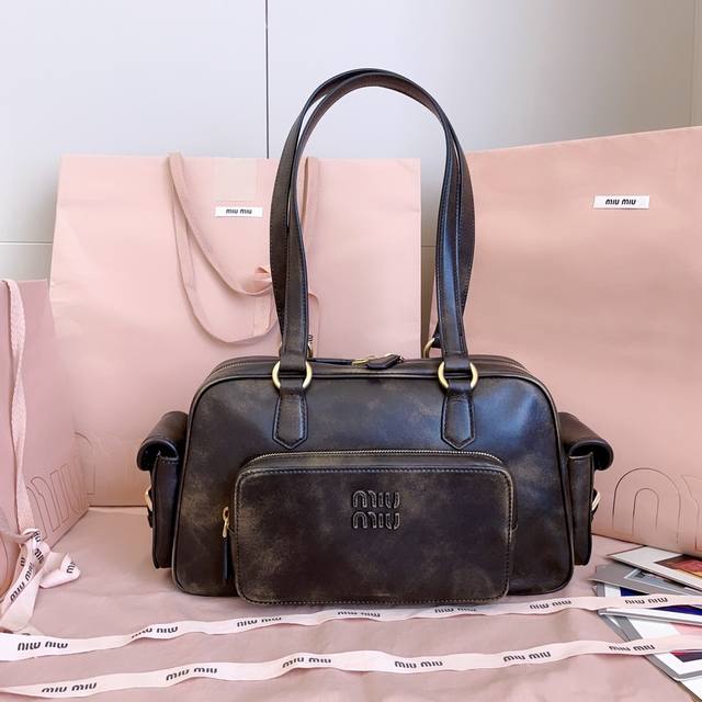 5Bb179, Miu's new vintage motorcycle bag, featuring a distinctive design. Heavil