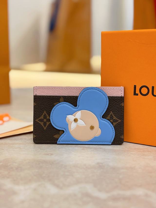 M15345 Christmas Edition Card Holder. This Vivienne card holder features a Monog