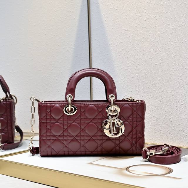 Large horizontal burgundy Lady D-Joy handbag with flap and two magnets embodies