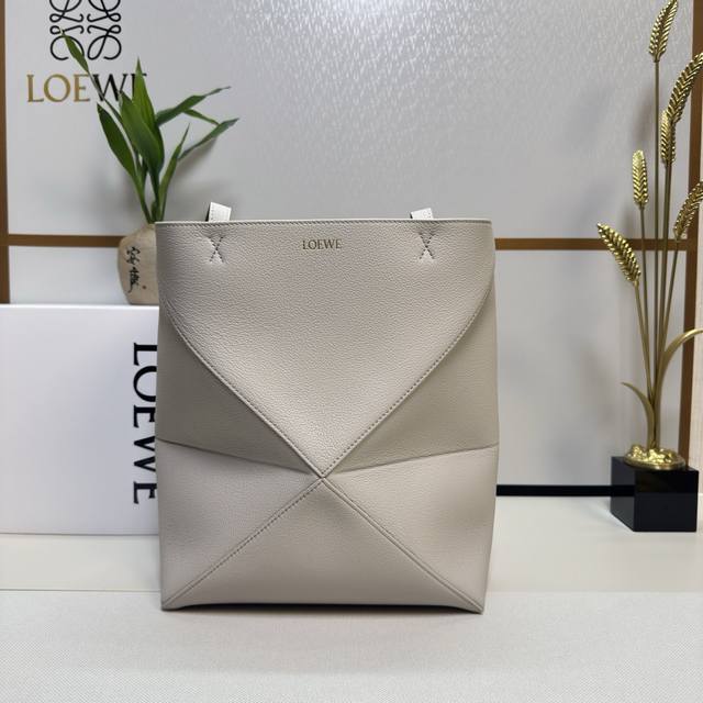 Lw New Small Soft Grained Calfskin Puzzle Fold Tote features a lightweight geome