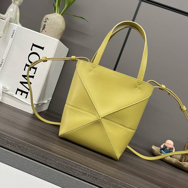 The new Loewe mini Puzzle Fold handbag in glossy calfskin draws inspiration from