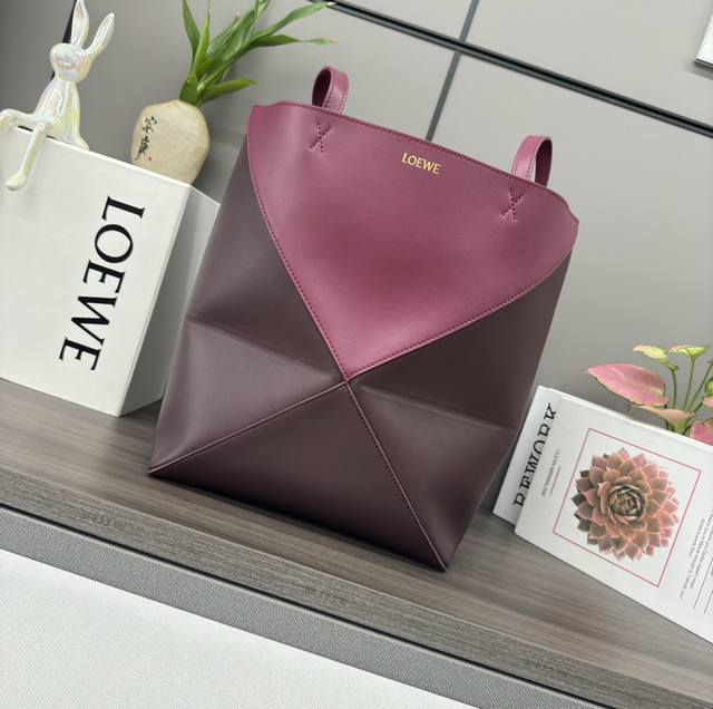Lw's new small two-tone glossy calfskin Puzzle Fold Tote features the iconic geo