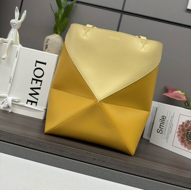 Lw's new small two-tone glossy calfskin Puzzle Fold Tote features the iconic geo