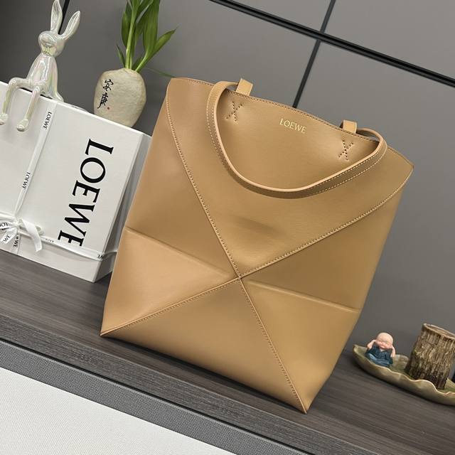 The new Lw small glossy calfskin Puzzle Fold Tote features the iconic geometric