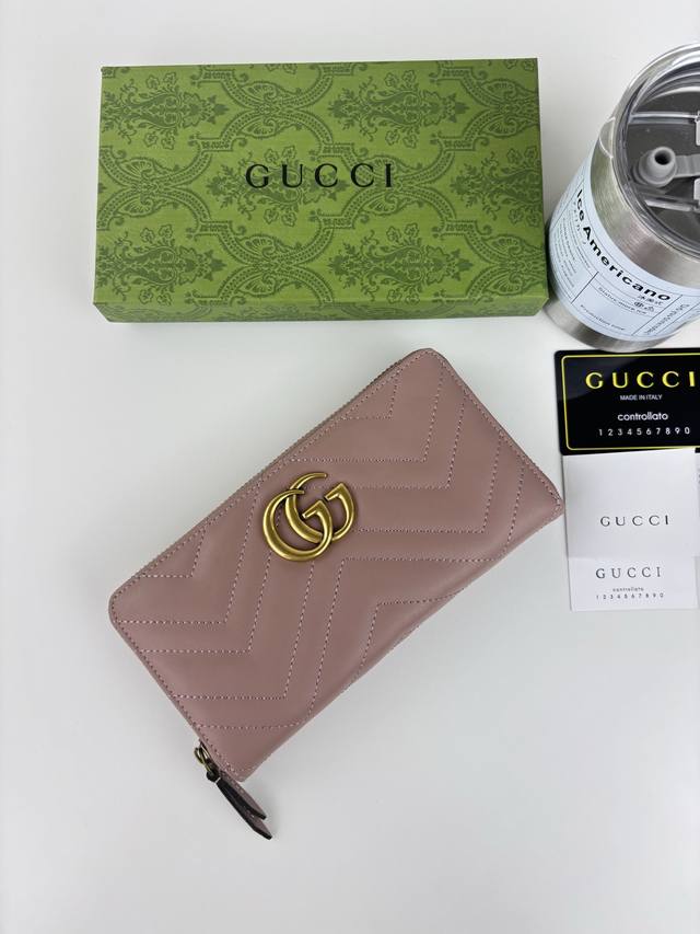 Guccl Gg Marmont Long Zip Wallet. Features a quilted design, embroidered Gg logo