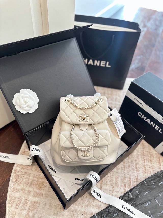 Cowhide leather Chanel 25P Duma backpack in folding gift box packaging. Features