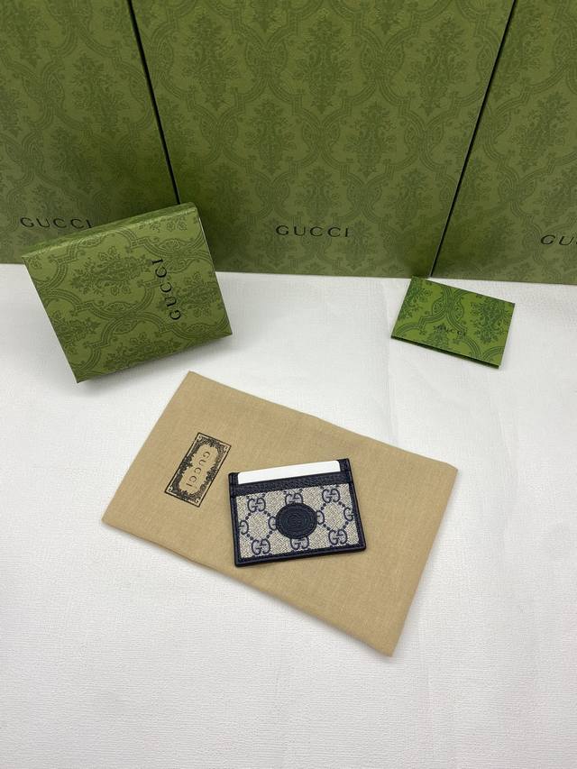 Comes in a green box. This sleek and slim wallet is crafted from blue Gg Suprem