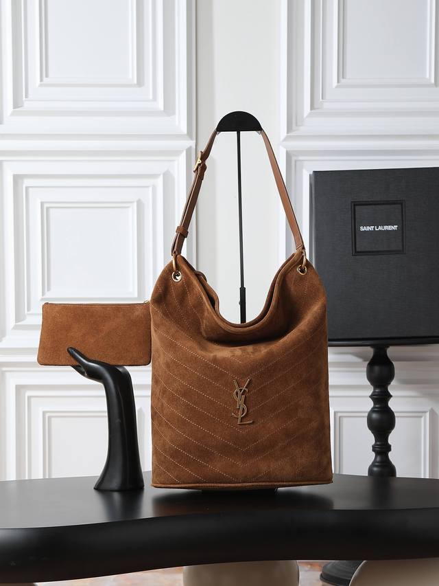 Niki's new suede bucket bag Adorned with Le Cassandre and V-shaped quilted stitc