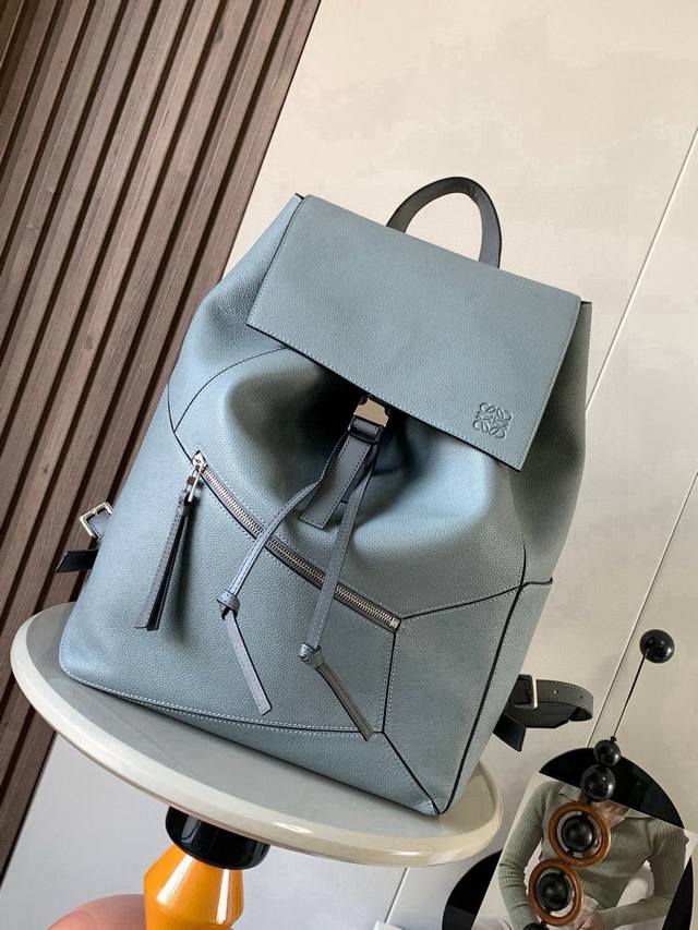 puzzle Backpack This military-style backpack is made of soft grained calfskin le