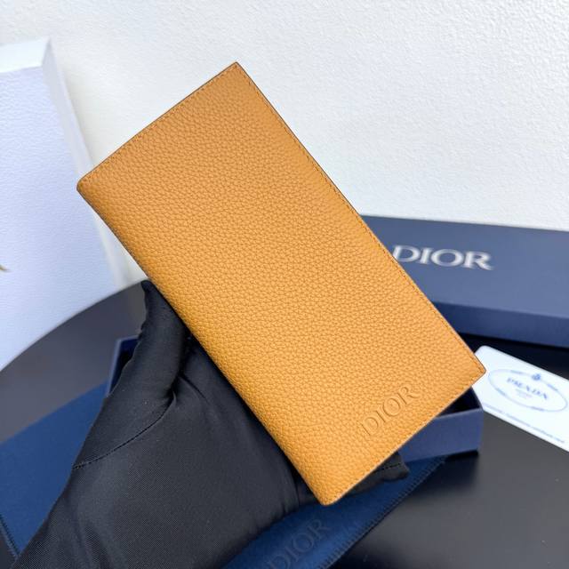 This stylish and functional vertical bi-fold wallet is crafted from premium cow