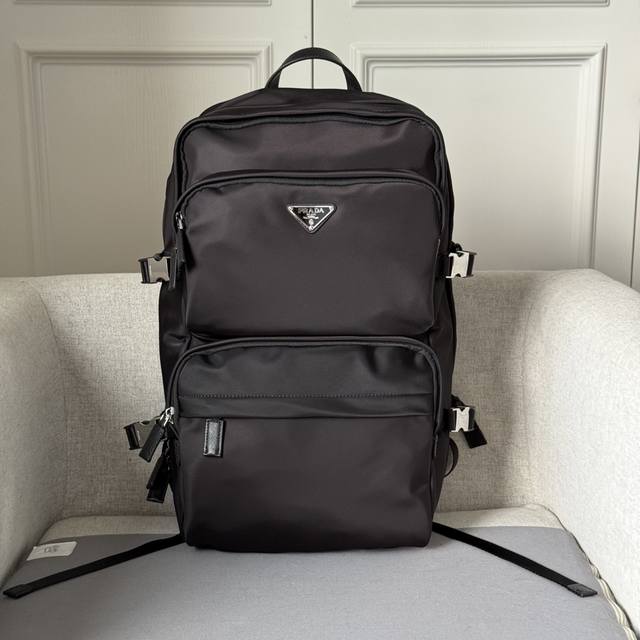 This spacious Re-Nylon backpack boasts a tech-inspired look. Made from recycled