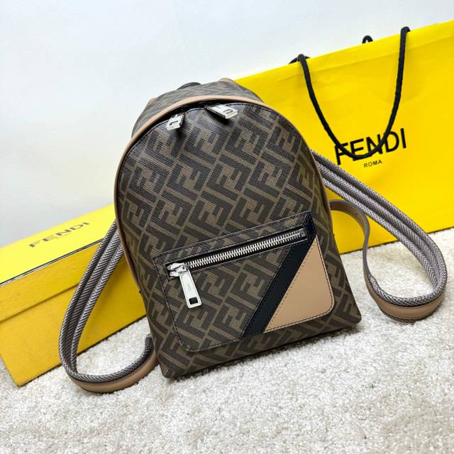 Small Structured Backpack. This design features a metal stud engraved with the