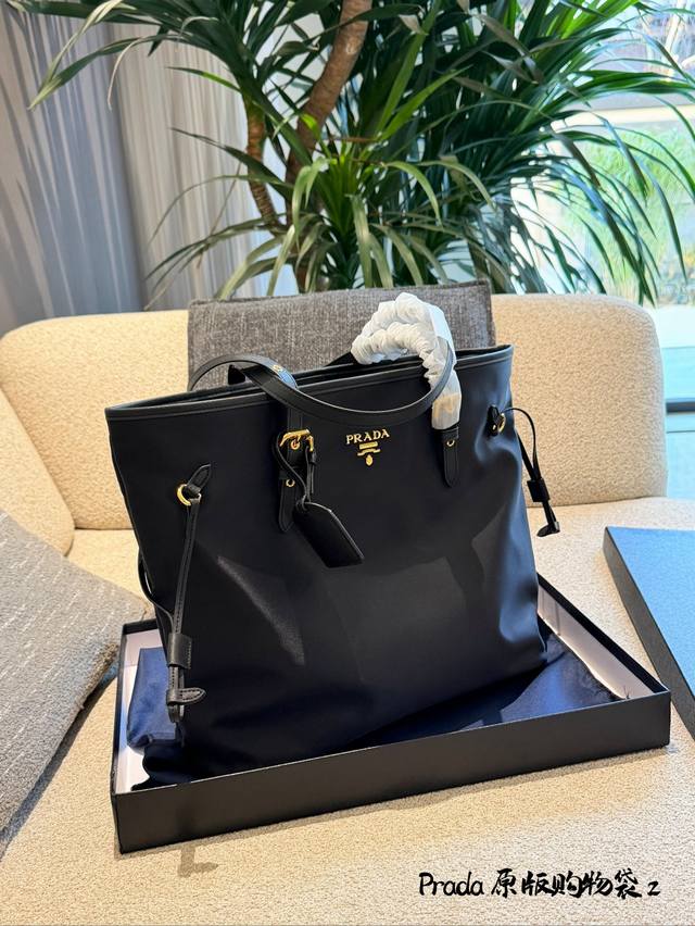Prada Black and Gold Nylon Tote Bag This Prada black and gold nylon tote bag fe