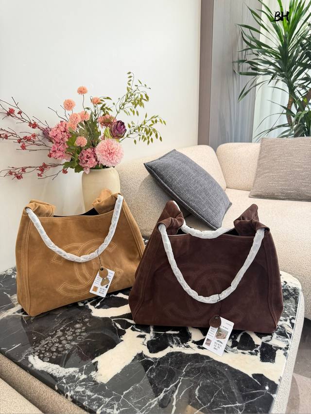 Used Chanel Suede Tote Bag This used Chanel suede tote bag is made of soft and t