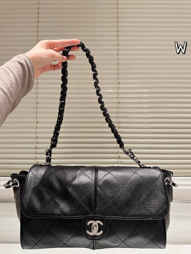 Dark, powerful female lead, chic and languid Chanel black and silver cable knit