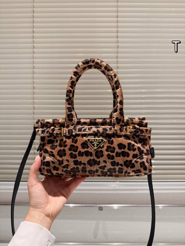 prada Bonnie Handbag &prada Bonnie handbag is made of black and white cow-print