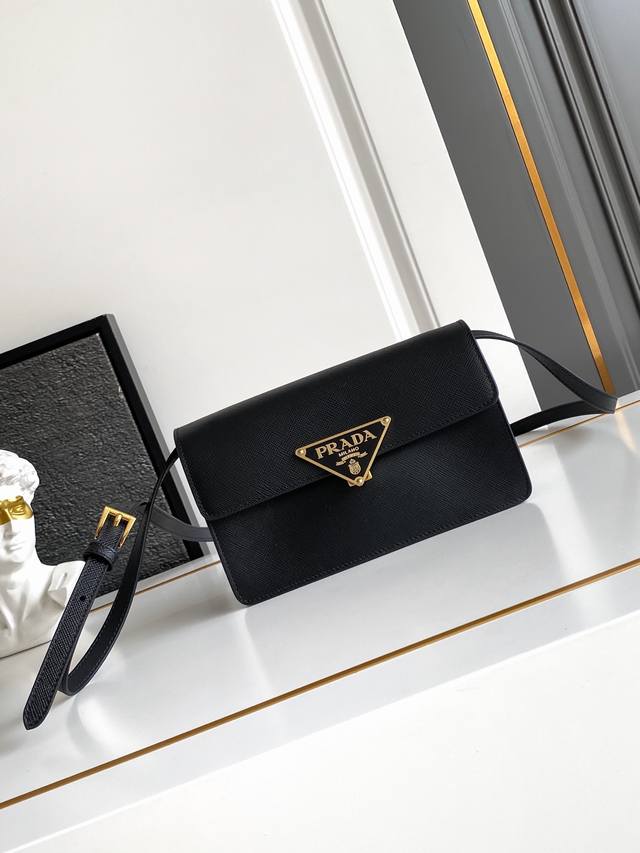 New Mini This mini handbag is crafted from Saffano calfskin. The structured silh