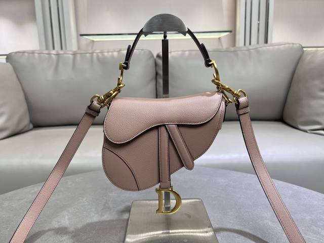 The small, light pink saddle bag with shoulder strap is the king of kings, its