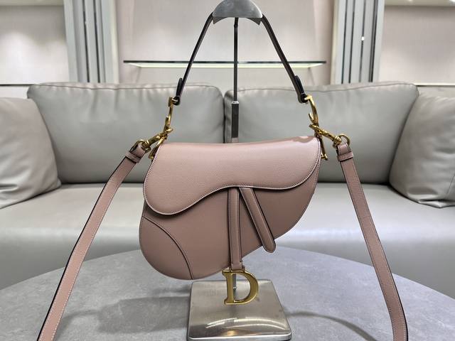 The large, light pink saddle bag with shoulder strap is the king of kings, its
