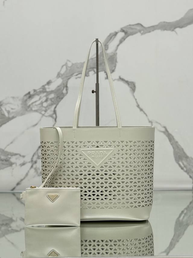 Authentic Perforated Tote Bag. This bag is crafted from imported calfskin with a
