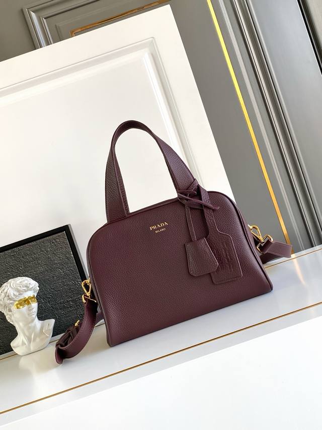 Authentic New This top-handle bag, crafted from natural grain leather, has been