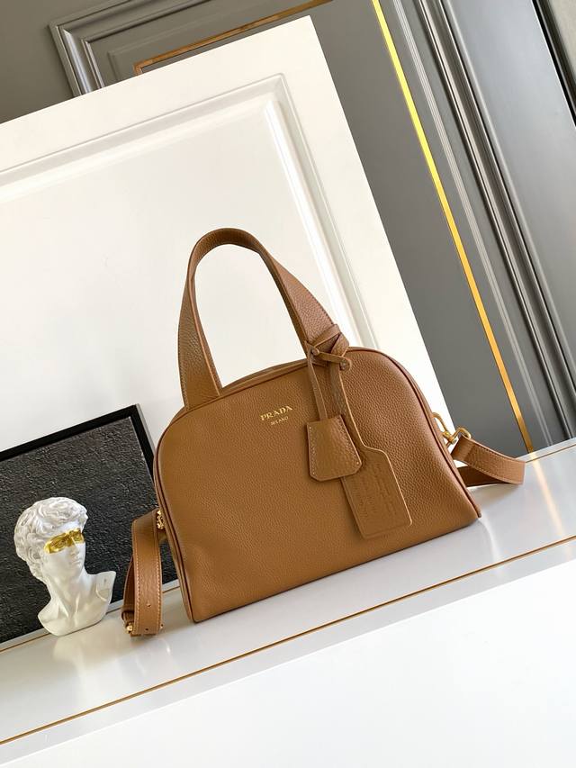 Authentic New This top-handle bag, crafted from natural grain leather, has been