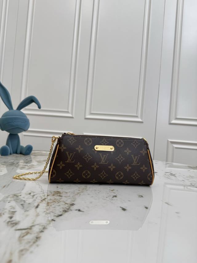 M13567 This Pochette Eva handbag features the brand's Monogram canvas with contr