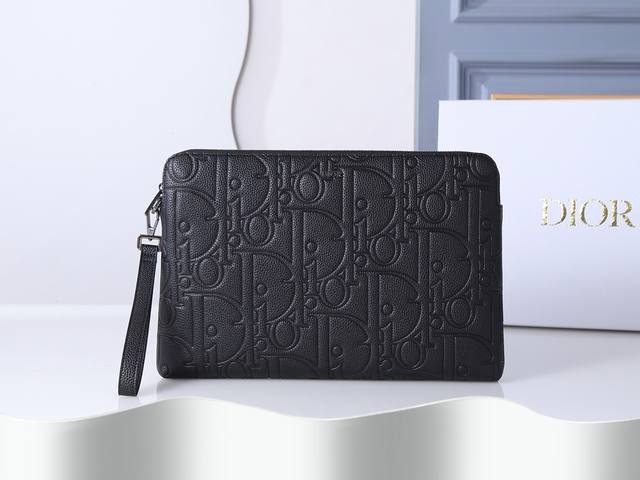 Style No. 421 This A4-sized zip-up clutch in black embossed fabric is a Dior pr