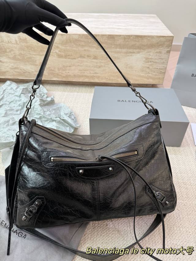 Replica Cowhide Balenciaga Le City Moto Bag. Made of black waxed cowhide with a